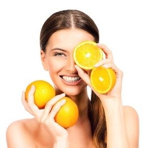43906352 - joyful young woman holding juicy oranges before her eyes
