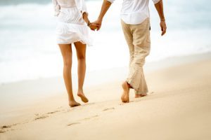 47338484 - back view of a barefoot couple walking